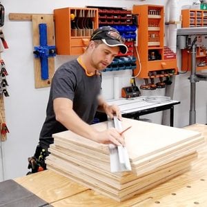 man building with wood in a workshop