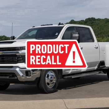 A White 2024 Chevrolet Silverado 3500 HD, One Of Four Truck Models Recalled By GM In December 2024, Sits Parked on Asphalt